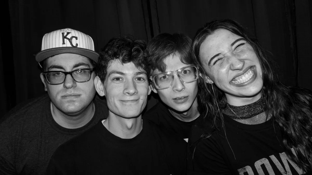 The Filibusters posing together in a candid black-and-white band photo.